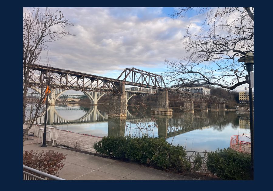Railroad bridge spanning the Tennessee River in downtown Knoxville with calm water reflections
