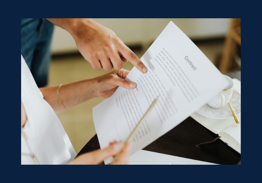 Buyer reviewing and signing a real estate agreement with agent before touring homes.