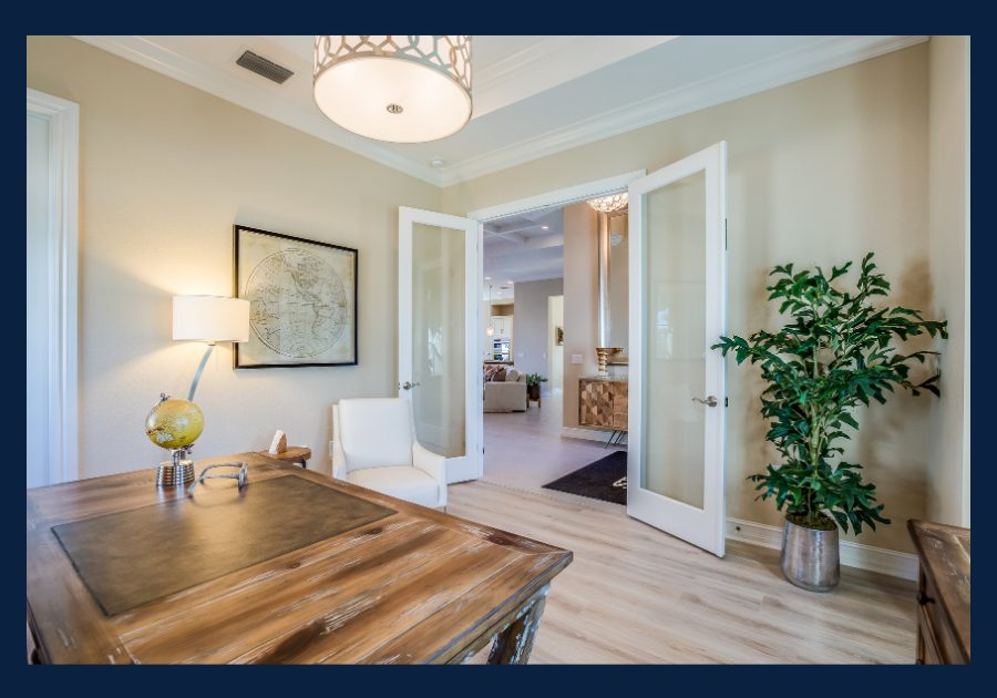 Staged home office with desk and open doors leading into living space